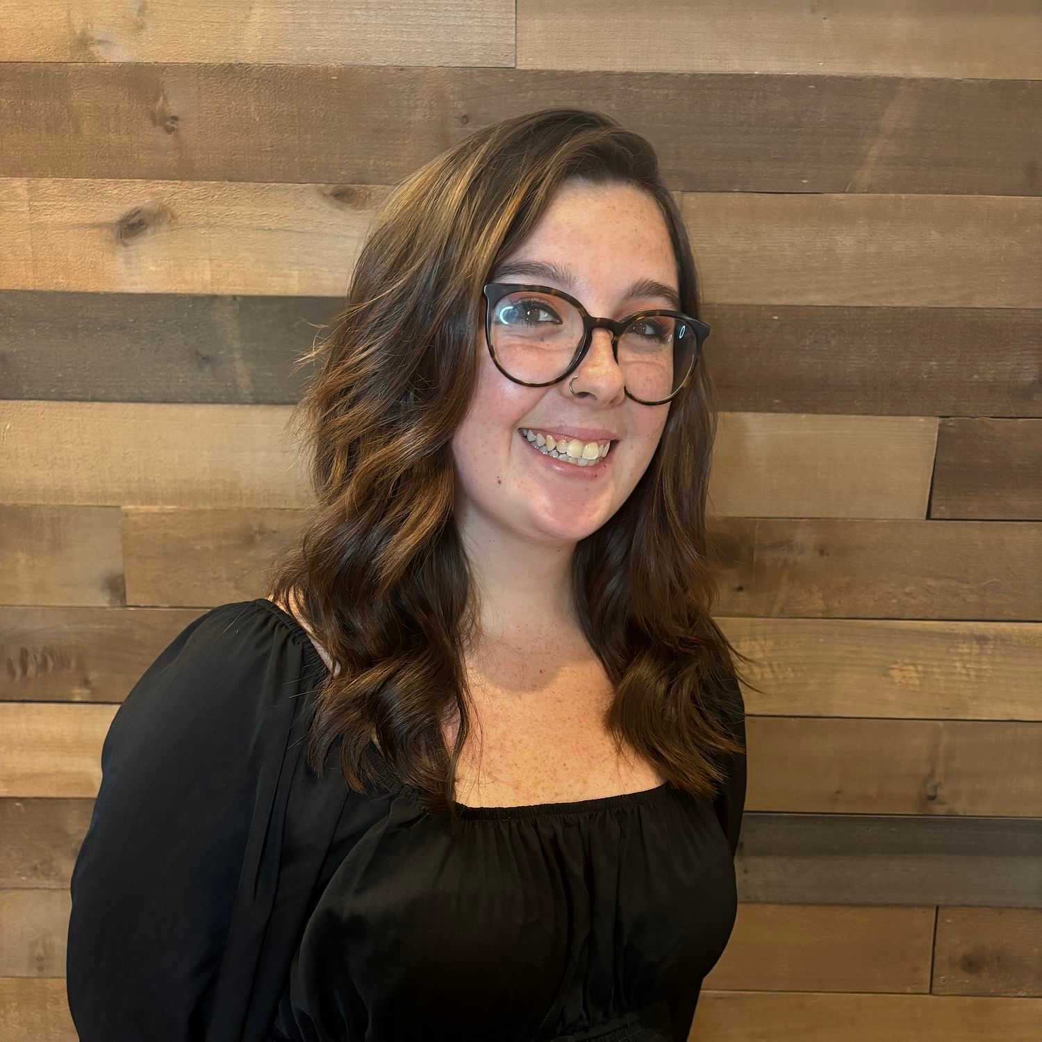 Portrait of Kylee, a professional stylist at Laschi Hairstylists & Day Spa, showcasing their expertise and style.