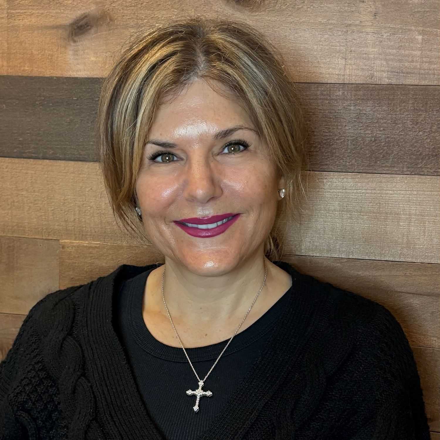 Portrait of Jodi, a professional stylist at Laschi Hairstylists & Day Spa, showcasing their expertise and style.