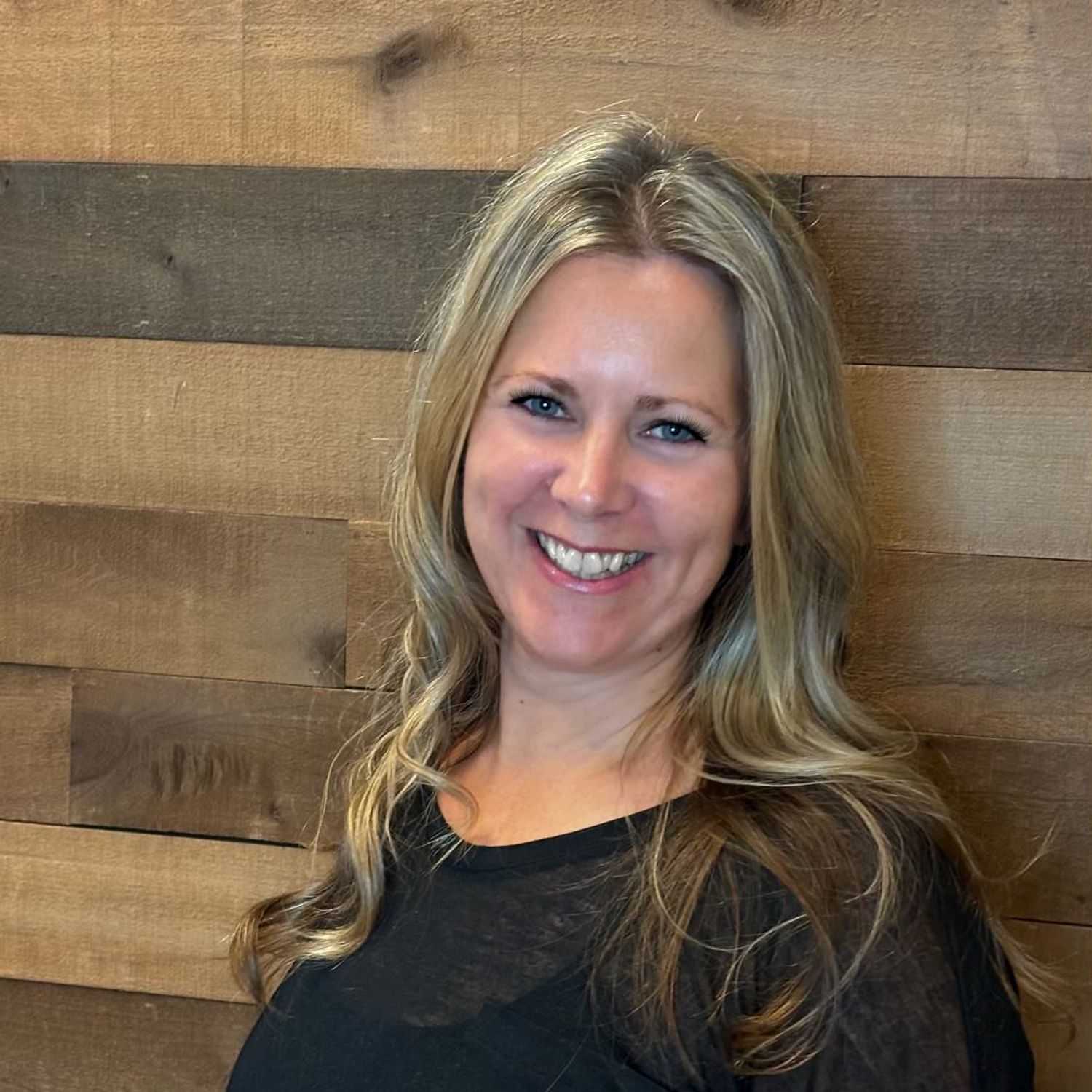 Portrait of Kelley, a professional stylist at Laschi Hairstylists & Day Spa, showcasing their expertise and style.