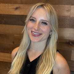 Portrait of Kenzie, a professional stylist at Laschi Hairstylists & Day Spa, showcasing their expertise and style.