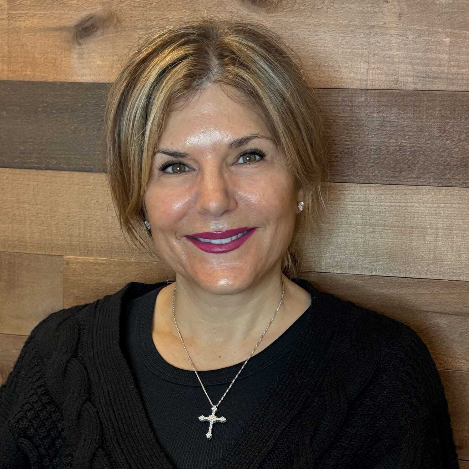 Portrait of Jodi, a professional stylist at Laschi Hairstylists & Day Spa, showcasing their expertise and style.